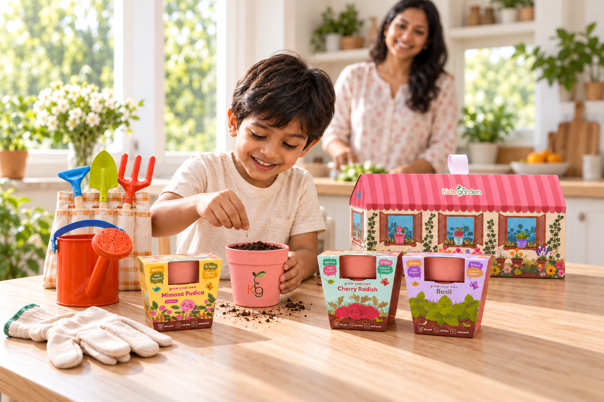 Indian boy planting a seed in a pink Kids Garden pot with the complete Little Gardener Set, unopened grow kits and a parent in the background