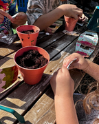 Family sharing their Kids Garden planting experience